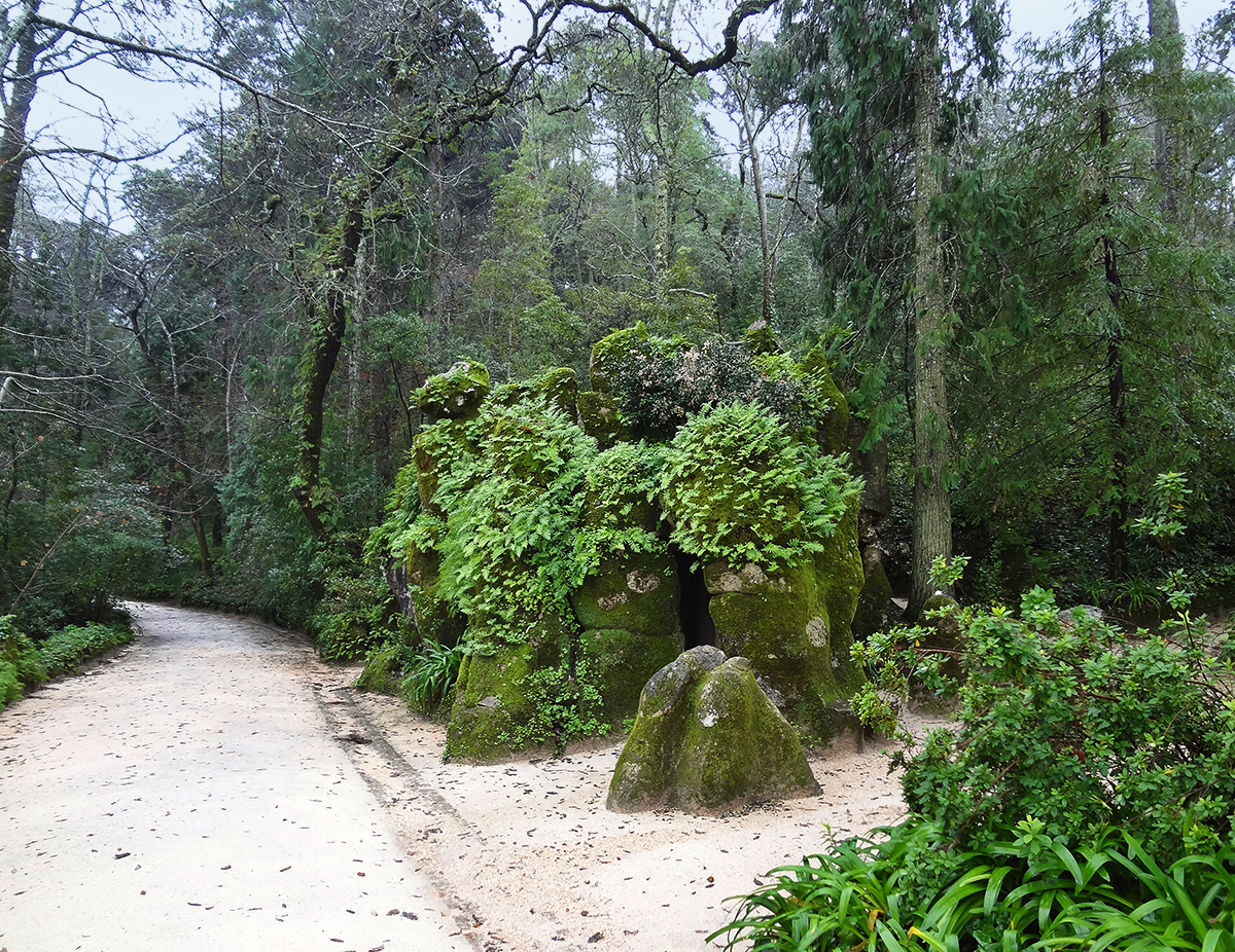 The masked entrance to Initiation Well in the garden of Quinta da Regaleira, Sintra, Portugal.